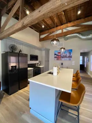 a kitchen with a white counter and a black refrigerator at Condo in OTR, Pendleton Art District in Cincinnati