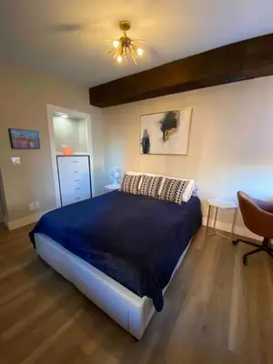 a bedroom with a blue bed and a ceiling fan at Condo in OTR, Pendleton Art District in Cincinnati