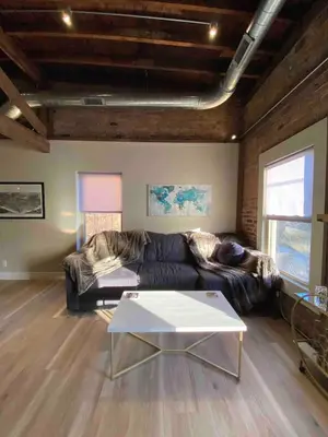 a living room with a couch and a table at Condo in OTR, Pendleton Art District in Cincinnati
