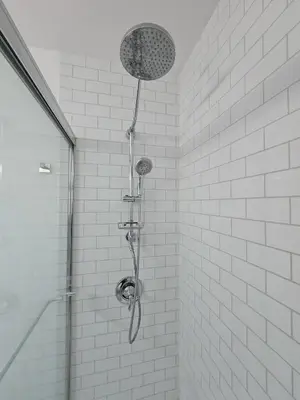 a shower with a shower head in a bathroom at The Wilderness, Near CP & SF, W&D, Pet OK in Sandusky