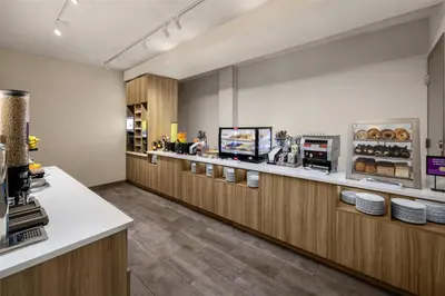 a cafeteria with a counter and aasteryasteryasteryasteryasteryasteryasteryasteryastery at Home2 Suites By Hilton Dry Ridge in Dry Ridge