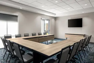 a conference room with a large table and chairs at Home2 Suites By Hilton Dry Ridge in Dry Ridge