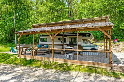 a rv with a gazebo in the woods at Gorgeous Caravan Glamping Escape for Four in Dover, Ohio in Dover
