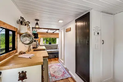 a tiny house with a kitchen and a living room at Gorgeous Caravan Glamping Escape for Four in Dover, Ohio in Dover