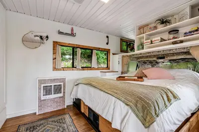 a bedroom with a large bed and a window at Gorgeous Caravan Glamping Escape for Four in Dover, Ohio in Dover