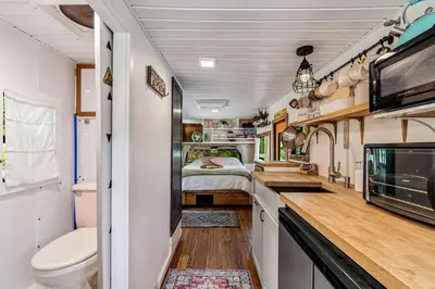 a kitchen with a toilet and a bed in a trailer at Gorgeous Caravan Glamping Escape for Four in Dover, Ohio in Dover