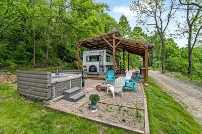 a rv with a gazebo and a table and chairs at Gorgeous Caravan Glamping Escape for Four in Dover, Ohio in Dover