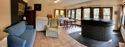a living room with a blue couch and a table at Cozy Studio Cabin Rental with Hot Tub Perfect for Glamping in Ohio in Logan