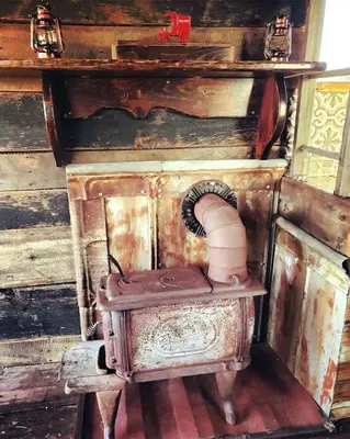 an old sewing machine sitting next to a wooden wall at Rustic Container Accommodation for Glamping in Kentucky in Owenton