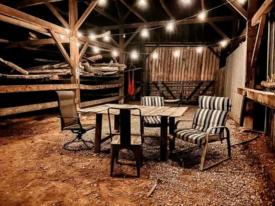 a room with a wooden table and chairs and lights at Cozy Hot Tub “Love Bus” near Augusta, Kentucky in Germantown
