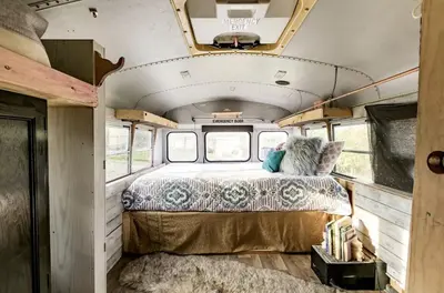 a bedroom in an rv with a bed in it at Cozy Hot Tub “Love Bus” near Augusta, Kentucky in Germantown