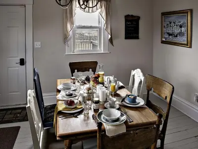 a dining room table with plates and dishes on it at Charming Weekend Getaway Located on a Vineyard near Cleveland, Ohio in Berlin Center