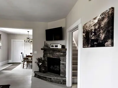 a living room with a fireplace with a tv on top at Charming Weekend Getaway Located on a Vineyard near Cleveland, Ohio in Berlin Center