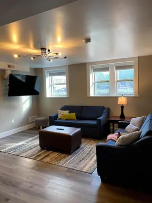 a living room with two couches and a flat screen tv at Cle Suites 3BR 2BA 5 min Walk to Cle Clinic Unit 2 in Cleveland