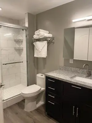 a bathroom with a toilet and a sink and a shower at Cle Suites 3BR 2BA 5 min Walk to Cle Clinic Unit 2 in Cleveland
