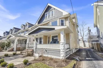 a large white house with a porch at Stylish Retreat by Shaker Square, Fast WiFi, Porch in Cleveland