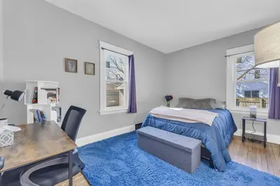 a bedroom with a bed and a desk and windows at Stylish Retreat by Shaker Square, Fast WiFi, Porch in Cleveland