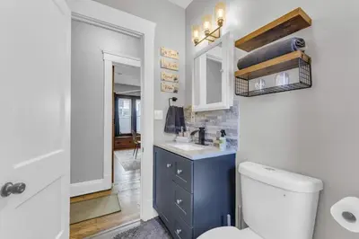 a bathroom with a white toilet and a sink at Stylish Retreat by Shaker Square, Fast WiFi, Porch in Cleveland