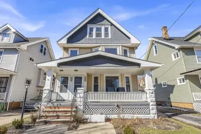 a house with a white front porch at Stylish Retreat by Shaker Square, Fast WiFi, Porch in Cleveland
