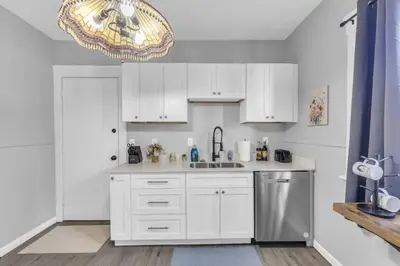 a kitchen with white cabinets and a sink at Stylish Retreat by Shaker Square, Fast WiFi, Porch in Cleveland