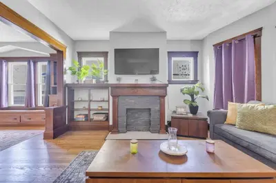 a living room with a couch and a fireplace at Stylish Retreat by Shaker Square, Fast WiFi, Porch in Cleveland