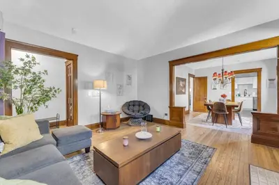 a living room with a couch and a table at Stylish Retreat by Shaker Square, Fast WiFi, Porch in Cleveland