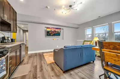 a kitchen with a couch in the middle of a room at Cle Suites 2BR 1BA 5 min Walk to Cle Clinic Unit 4 in Cleveland