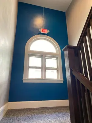 a blue room with a window with an exit sign at Cle Suites 1BR 1BA 5 min Walk to Cle Clinic Unit 6 in Cleveland