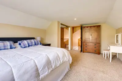 a bedroom with a large white bed and a desk at Game Room and On-Site Pond Laurelville Retreat! in Laurelville