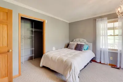 a bedroom with a bed and a window at Game Room and On-Site Pond Laurelville Retreat! in Laurelville