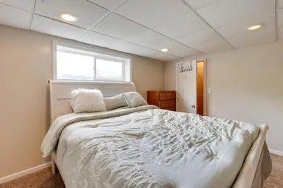 a bedroom with a large white bed with a window at Game Room and On-Site Pond Laurelville Retreat! in Laurelville