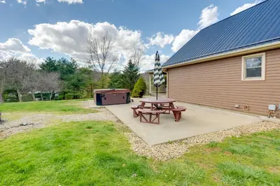 a picnic table and a barbecue next to a building at Game Room and On-Site Pond Laurelville Retreat! in Laurelville