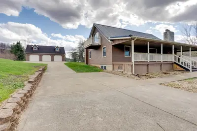 a house with a porch and a driveway at Game Room and On-Site Pond Laurelville Retreat! in Laurelville