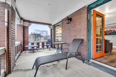 a patio with a chair and tables on a brick wall at Cle Suites 1BR 1BA 5 min Walk to Cle Clinic #7 in Cleveland