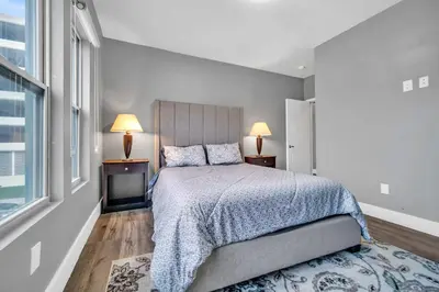 a bedroom with a bed and two lamps and a window at Cle Suites 2BR 1BA 5 min Walk to Cle Clinic #8 in Cleveland