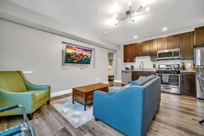 a kitchen and living room with two chairs and a couch at Cle Suites 1BR 1BA 5 min Walk to Cle Clinic #11 in Cleveland