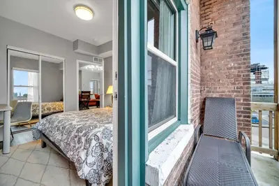 a bedroom with a bed and a large window at Cle Suites 2BR 1BA 5 min Walk to Cle Clinic #9 in Cleveland