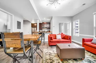 a dining room and living room with a table and chairs at Cle Suites 2BR 1BA 5 min Walk to Cle Clinic #14 in Cleveland