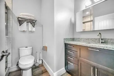 a white bathroom with a toilet and a sink at Cle Suites 2BR 1BA 5 min Walk to Cle Clinic #14 in Cleveland