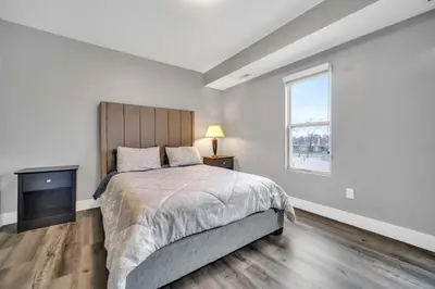 a bedroom with a large bed and a window at Cle Suites 1BR 1BA 5 min Walk to Cle Clinic #15 in Cleveland