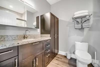 a white bathroom with a toilet and a sink at Cle Suites 1BR 1BA 5 min Walk to Cle Clinic #15 in Cleveland