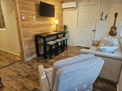 a living room with a couch and a table at College Park Bungalow in Winchester
