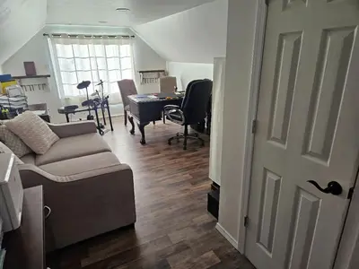 a living room with a couch and a table at College Park Bungalow in Winchester