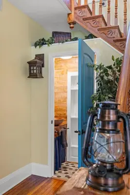 a hallway with a blue door and a stairway at College Park Getaway in Winchester