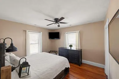 a bedroom with a bed and a ceiling fan at College Park Getaway in Winchester