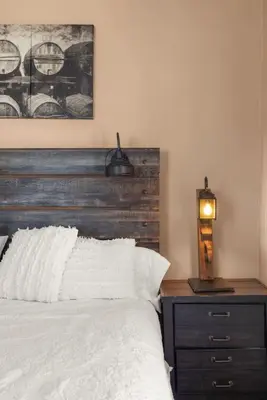 a bedroom with a bed with a wooden headboard at College Park Getaway in Winchester