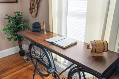 a table with a laptop and a candle on it at College Park Getaway in Winchester