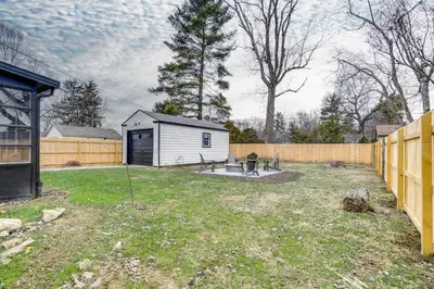 a backyard with a shed and a fence at Screened Patio and Fire Pit Modern Westerville Home in Westerville