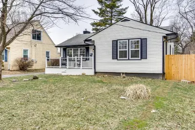 a white house with a fence in a yard at Screened Patio and Fire Pit Modern Westerville Home in Westerville