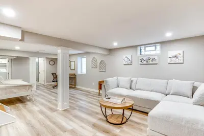 a living room with a couch and a table at Screened Patio and Fire Pit Modern Westerville Home in Westerville